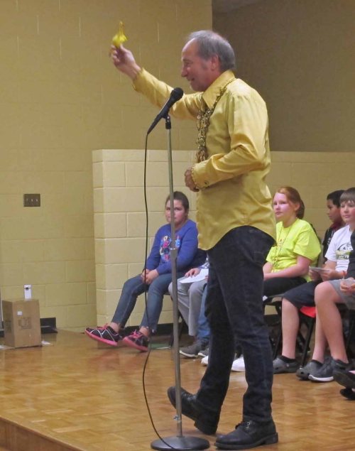 Clayton Scott, guest poet, reminding students to confront and defeat their "inner chicken."